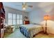 Bedroom with double bed, chair, and built-in shelving at 680 71St Ave # 14, St Pete Beach, FL 33706