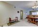 Dining area with wood table and chairs, view into living room at 680 71St Ave # 14, St Pete Beach, FL 33706