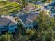 Aerial view of the home showcasing landscaping, and surrounding neighborhood at 6972 Ripple Pond Loop, Zephyrhills, FL 33541