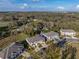 Expansive aerial shot showcasing townhomes in a tranquil community with a backdrop of lush greenery and scenic beauty at 6972 Ripple Pond Loop, Zephyrhills, FL 33541