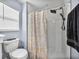 Modern bathroom featuring a toilet, window, and a tiled shower with rainfall shower head at 6972 Ripple Pond Loop, Zephyrhills, FL 33541