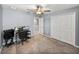 Bedroom with a ceiling fan and a desk with a computer at 6972 Ripple Pond Loop, Zephyrhills, FL 33541