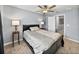 Bedroom featuring a bed, two side tables, a ceiling fan and a doorway into another room at 6972 Ripple Pond Loop, Zephyrhills, FL 33541