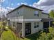 Exterior view of the home with a screened lanai and well-manicured lawn at 6972 Ripple Pond Loop, Zephyrhills, FL 33541