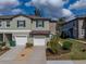 Charming townhome showcasing a stone accent wall, attached garage, and manicured landscaping, offering suburban living at 6972 Ripple Pond Loop, Zephyrhills, FL 33541