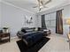 Living room featuring a modern gray sectional, tile floors, and contemporary decor at 6972 Ripple Pond Loop, Zephyrhills, FL 33541