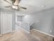 A loft area is carpeted and features a ceiling fan, a closet, and a railing overlooking the lower level at 6972 Ripple Pond Loop, Zephyrhills, FL 33541