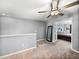 Loft featuring neutral carpet, a ceiling fan and a doorway into another bedroom at 6972 Ripple Pond Loop, Zephyrhills, FL 33541