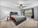 Spacious bedroom featuring a ceiling fan, carpeted flooring, and natural light from the window at 6972 Ripple Pond Loop, Zephyrhills, FL 33541