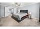 Large bedroom featuring a ceiling fan, neutral paint, carpeted flooring, and an adjoining hallway at 6972 Ripple Pond Loop, Zephyrhills, FL 33541