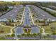 Street view with rows of townhomes, palm trees and an electronic gate for the Villas at Abbott Square at 6972 Ripple Pond Loop, Zephyrhills, FL 33541