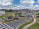 Street view with community sign and entry gate for the Villas at Abbott Square with a blue sky backdrop at 6972 Ripple Pond Loop, Zephyrhills, FL 33541