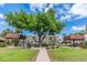 Relaxing community space with grills, picnic tables, and benches under large shade tree at 7 Elgin Pl # 502, Dunedin, FL 34698