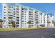 Condo building exterior, featuring a light-colored facade and blue roof at 7 Elgin Pl # 502, Dunedin, FL 34698