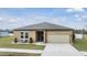 One-story home with a two-car garage and landscaped lawn at 701 Garden Oaks Sq, Seffner, FL 33584