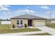 Tan one-story house with two-car garage at 701 Garden Oaks Sq, Seffner, FL 33584