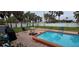 Backyard with pool, patio furniture and grass at 7063 S Shore S Dr, St Petersburg, FL 33707