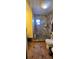 Bathroom with tiled shower and toilet, some damage present at 7063 S Shore S Dr, St Petersburg, FL 33707