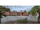 Front view of a single-story home with a covered entryway at 7063 S Shore S Dr, St Petersburg, FL 33707