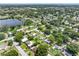 Aerial view showing the property's location in a residential neighborhood near a lake at 7234 12Th N St, St Petersburg, FL 33702