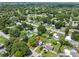 Aerial view showing home's location in a residential neighborhood with lush green trees at 7234 12Th N St, St Petersburg, FL 33702