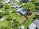 Aerial view showcasing a house's backyard, landscaping, and surrounding homes at 7234 12Th N St, St Petersburg, FL 33702