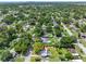 Aerial view showing home's location in a residential neighborhood with lush green trees at 7234 12Th N St, St Petersburg, FL 33702