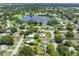 Aerial view showcasing a house's neighborhood setting, including a nearby lake at 7234 12Th N St, St Petersburg, FL 33702