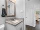 Clean bathroom with granite countertop and a framed mirror at 7234 12Th N St, St Petersburg, FL 33702