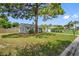 House with gray siding, large tree, and spacious lawn at 7234 12Th N St, St Petersburg, FL 33702