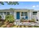 Charming single story home with a blue door and landscaped front yard at 7234 12Th N St, St Petersburg, FL 33702