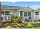 Gray house with blue door, stone walkway, and lush landscaping at 7234 12Th N St, St Petersburg, FL 33702