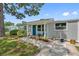 Charming house with gray siding, blue door, and landscaped walkway at 7234 12Th N St, St Petersburg, FL 33702