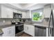 Bright kitchen boasts stainless steel appliances and granite countertops at 7234 12Th N St, St Petersburg, FL 33702