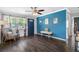 Living room with blue accent wall and hardwood floors at 7234 12Th N St, St Petersburg, FL 33702