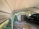 Carport with storage shed and space for a vehicle at 804 E 128Th Ave, Tampa, FL 33612