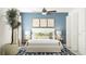 Bedroom with a queen bed, blue accent wall, and stylish decor at 8418 Bella Mar Trl, Parrish, FL 34219