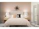 Bedroom with queen bed and blush pink color scheme at 9389 Runaway Breeze Dr, Land O Lakes, FL 34637