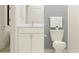 Bathroom with white vanity, toilet, and shower at 9728 Runaway Breeze Dr, Land O Lakes, FL 34637