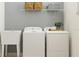 Bright laundry room with washer, dryer, and utility sink at 9728 Runaway Breeze Dr, Land O Lakes, FL 34637