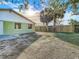 Green house exterior and fenced backyard at 10214 Turtle Hill Ct, Tampa, FL 33615