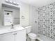 Updated bathroom with patterned tile shower and white vanity at 10214 Turtle Hill Ct, Tampa, FL 33615