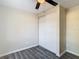 Bedroom with gray floors, ceiling fan, and double-door closet at 10214 Turtle Hill Ct, Tampa, FL 33615