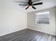 Bedroom with gray floors, ceiling fan and window at 10214 Turtle Hill Ct, Tampa, FL 33615