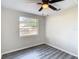 Bright bedroom with wood-look floors, window, and ceiling fan at 10214 Turtle Hill Ct, Tampa, FL 33615