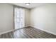 Simple bedroom with wood-look floors and sliding glass door at 10214 Turtle Hill Ct, Tampa, FL 33615