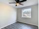 Spacious bedroom with gray floors, ceiling fan and backyard view at 10214 Turtle Hill Ct, Tampa, FL 33615