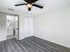 Bedroom with wood-look floors, double closets, and bathroom access at 10214 Turtle Hill Ct, Tampa, FL 33615