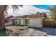 Front view of a light green house with a white door at 10214 Turtle Hill Ct, Tampa, FL 33615