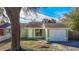 Exterior of a light green house with a white door at 10214 Turtle Hill Ct, Tampa, FL 33615